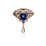 An Arts & Crafts brooch by Bernard Hertz, centred with a seed pearl-mounted blue enamel heart within