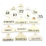 A collection of ceramic bin labels, some by Wedgwood, comprising: 'CLARET', 'SHERRY' (x2), 'MADEIRA'