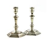 A pair of George I cast silver candlesticks, by David Green, London 1721, tapering hexagonal