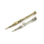 A Victorian novelty gold pencil, unmarked, faceted form, engraved decoration, mounted with a hand,