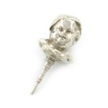 A novelty silver figural pencil, unmarked, modelled as a baby's head wearing a bonnet, length 4.2cm.