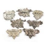 A collection of seven 19th century silver vine leaf wine labels, various dates and makers,