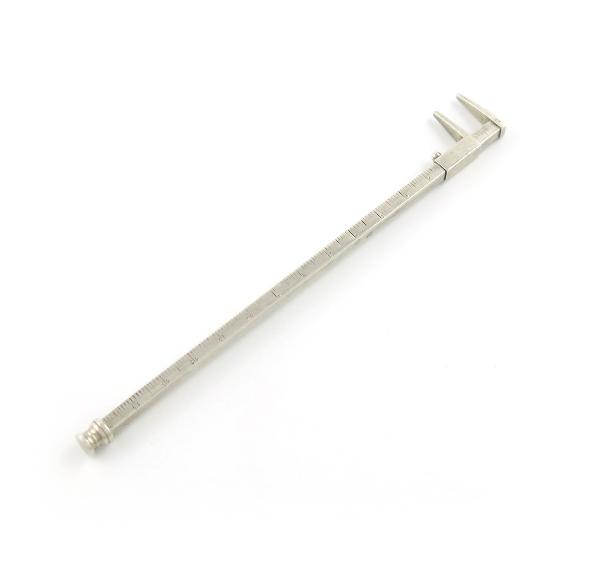 A novelty silver pencil, unmarked, modelled as a ruler with callipers, calibrated in inches,