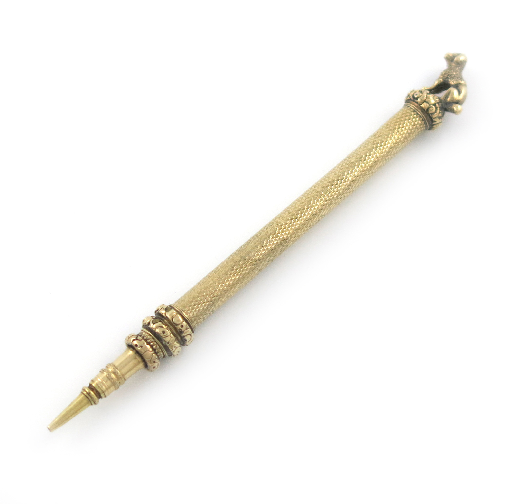 A Victorian gold pencil, unmarked, cylindrical form, engine-turned decoration, the finial set with a