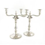 A pair of Austrian silver two-light candelabra, maker's mark VC, baluster columns, engine-turned