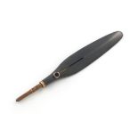 A gold-mounted gun metal combination pencil and paper knife, unmarked, plain feather form, the