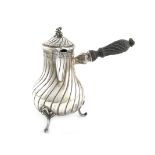 A late 19th century French silver hot water/milk pot, baluster form, swirl fluted decoration, turned