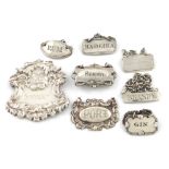 A mixed lot of eight small silver wine labels, various dates and makers, various designs, titled '
