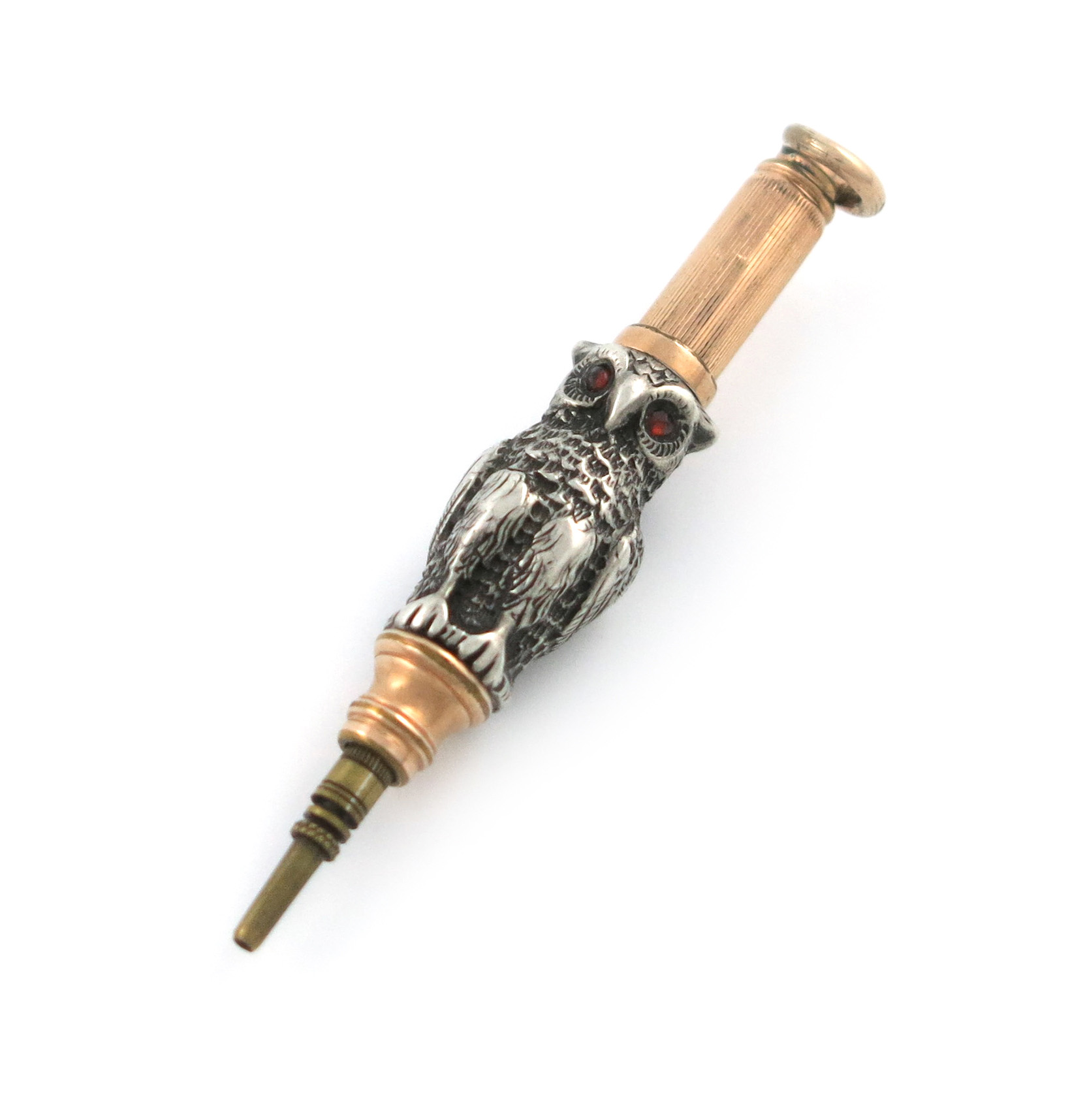 A Victorian novelty silver and gilt-metal pencil, unmarked, modelled as a standing owl, set with red