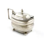 A George III silver mustard pot, marks worn, London 1810, rounded rectangular form, scroll handle,