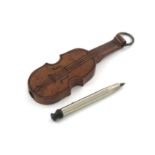 A novelty wooden pencil, unmarked, modelled as a violin, with a ring attachment, length 6.3cm.