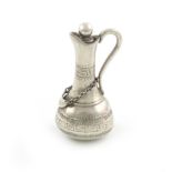 A Victorian novelty silver pencil, unmarked, modelled claret jug, with a hanging wine label