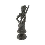 An Indian metal ware figure of a lady, unmarked, modelled in a standing position in traditional