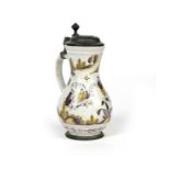 A German faïence pewter-mounted jug c.1761, the baluster form painted in manganese and yellow with