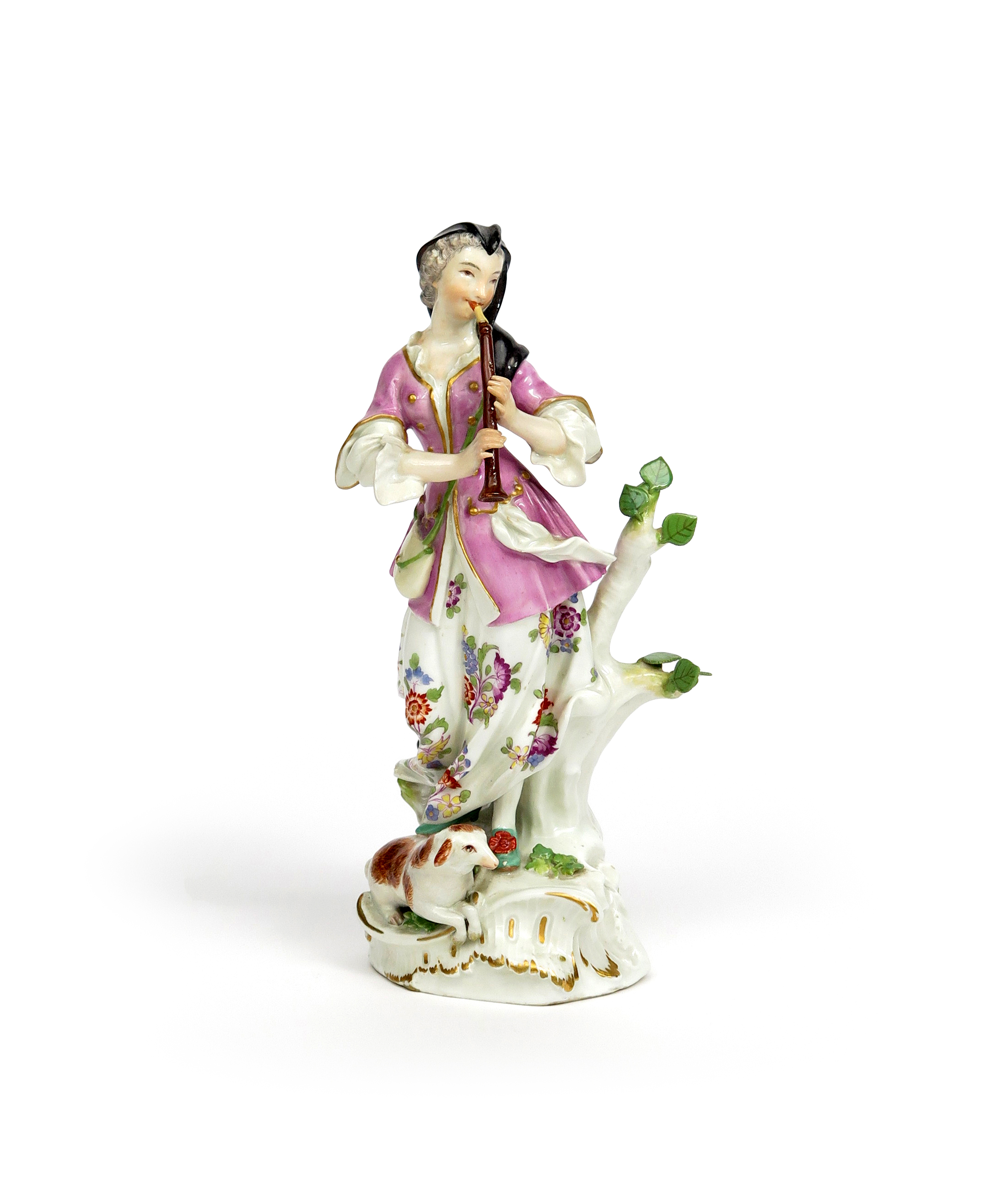 A Meissen figure of a musical shepherdess mid 18th century, playing the clarinet or recorder and