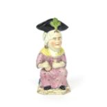 A Martha Gunn Toby jug c.1810, after the Wood model, seated and holding a bottle and a gin glass,