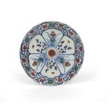 An early London delftware plate c.1715-25, painted in blue, red and green with stylized floral