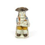 A good Pratt ware Toby jug c.1800, seated and resting a foaming jug of ale on his left knee, his