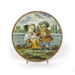 A small Castelli maiolica plate c.1740, painted with a dwarf reaching into the lap of a woman