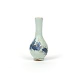 A rare miniature delftware bottle vase c.1720, possibly Bristol, painted in blue and managese with a