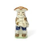 A Pratt ware Toby jug c.1800, of Ordinary type, seated with a foaming jug of ale, wearing a