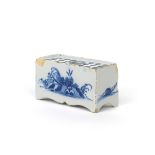 A small delftware flower brick c.1750, the rectangular form painted in blue with a stylized pagoda