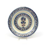 A large Portuguese faïence charger late 17th century Lisbon, painted in blue and manganese with a