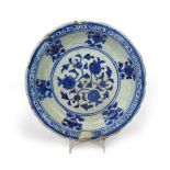 A Safavid 'Kubachi' dish 16th century, decorated in rich underglaze blue with a stylized