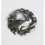 A Georg Jensen silver Dove brooch, model no.70, circular, pierced and cast with a dove before