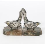 A pair of silvered metal book ends by Hippolyte Moreau, each modelled as a resting bird, with