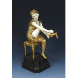 Affortunato Gori Vanity gilt bronze and ivory model of a young lady seated on a stool putting on a