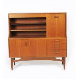 A G-Plan teak sideboard, on tapering legs, double cupboard below three drawers, drop-down drinks