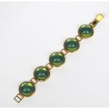 A modern Lalique gilt metal bracelet, five domed green glass panels, stamped Lalique mark, 16.5cm.