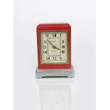 A French electric mantel clock, rectangular pillar box red body with stepped top, on stepped