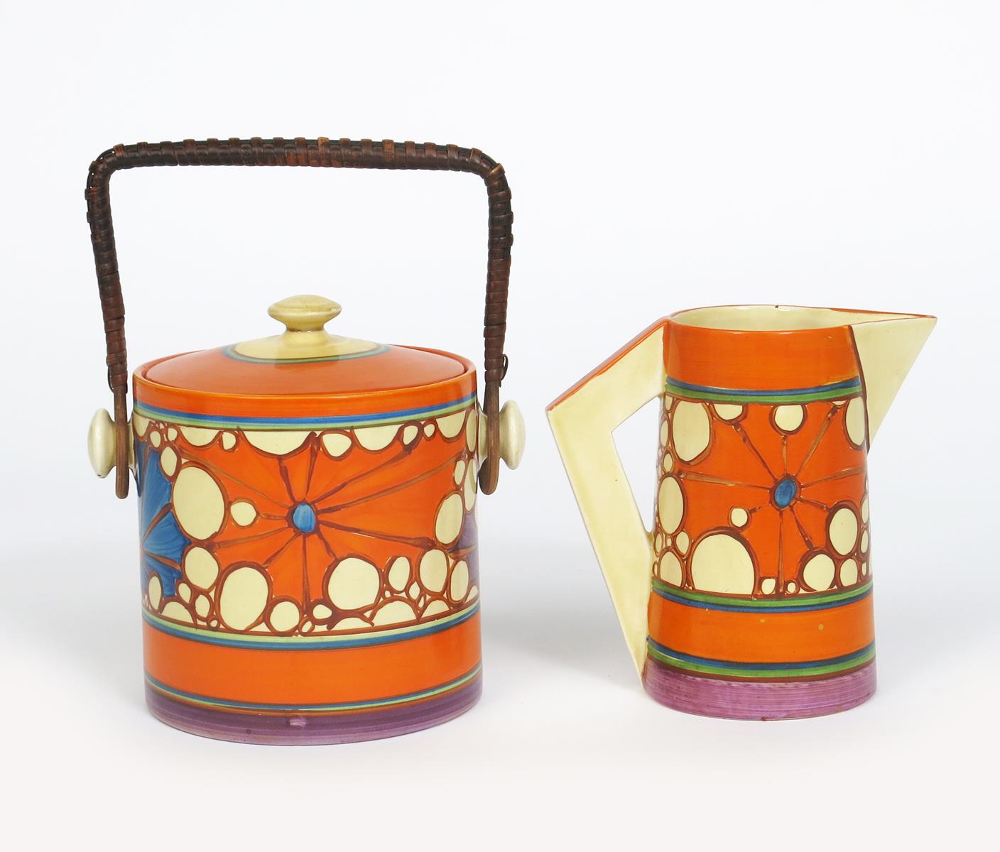 'Broth' a Clarice Cliff Fantasque Bizarre Cylindrical Biscuit barrel and cover and a Conical jug,