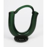 A Murano glass vase, the thick green tube glass with strap handle, on fluted foot, unsigned, 29cm.