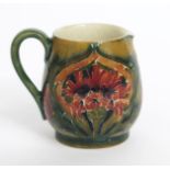 'Revived Cornflower' a Moorcroft Pottery miniature jug designed by William Moorcroft, painted in