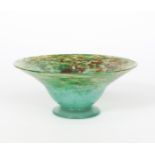 A Moncrieff's Monart Ware glass bowl on applied foot, mottled green glass with a cloud of orange and
