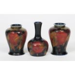 'Pomegranate' a near pair of Moorcroft Pottery vases designed by William Moorcroft, painted in