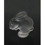 A frosted glass rabbit paperweight/mascot, on circular base, acid-etched mark to base, 12.5cm. high