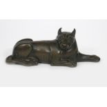 A patinated bronze model of a big cat, cast resting one front paw extended, head turned, stamped