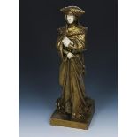 Desire Grisado (born 1872) Medieval Maiden a gilt bronze and ivory figure of a medieval maiden in