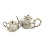 λA Chinese silver teapot and sugar bowl, by Hung Chong, circa 1920, circular form, applied blossom