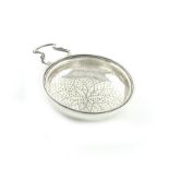 A George II / III silver lemon strainer, by Samuel Herbert and Co., London circa 1750-60, circular