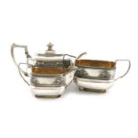λA three-piece George III silver tea set, by Alice and George Burrows, London 1809, rounded