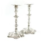 A matched pair of George II silver candlesticks, one by John Cafe, London 1756, the other by William
