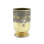 A Victorian parcel-gilt silver beaker, by Robert Garrard, London 1876, circular form, chased foliate