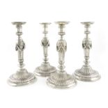 A set of four George III cast silver candlesticks, by John Romer, London 1769, in the classical