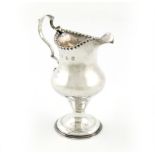 A George III silver cream jug, by Hester Bateman, London 1781, baluster form, punch bead border,