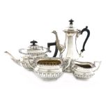 A three-piece silver tea set and a coffee pot, the tea set by Alexander Clark, Birmingham 1921,